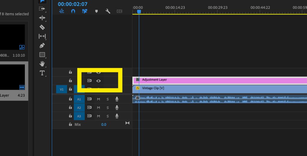 Screenshot of the timeline in Premiere Pro showing where you can turn the adjustment layer on or off by clicking on the eye next to it,.