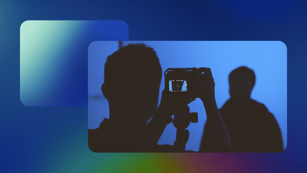 Image with a dark blue background and blue-green gradient in the upper left corner and an image of two silhoutted figures, one adjusting a camera and someone standing in front of the camera. The truth behind video marketing: debunking 8 common myths