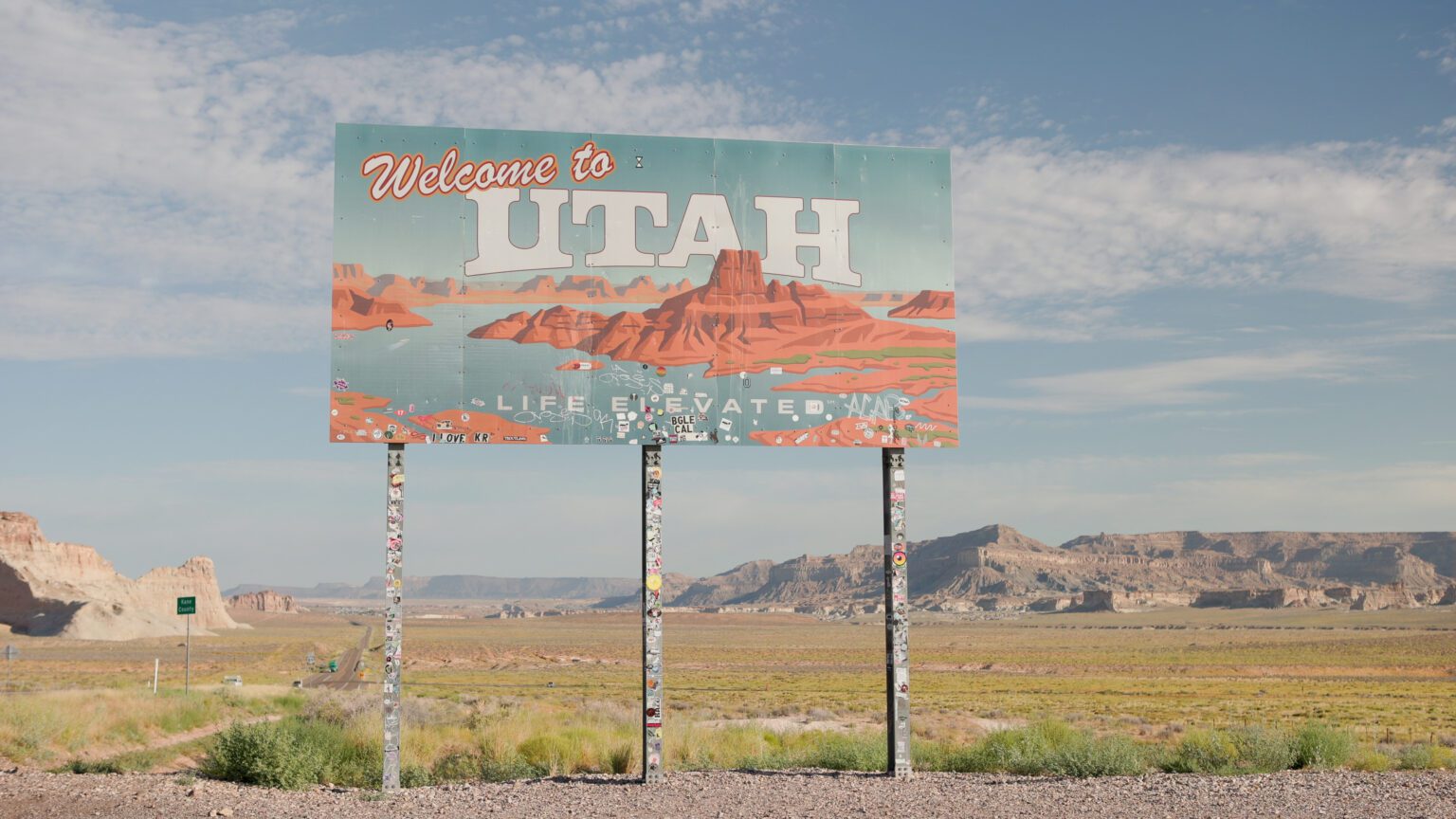 image of a welcome to Utah sign with a desert landscape
