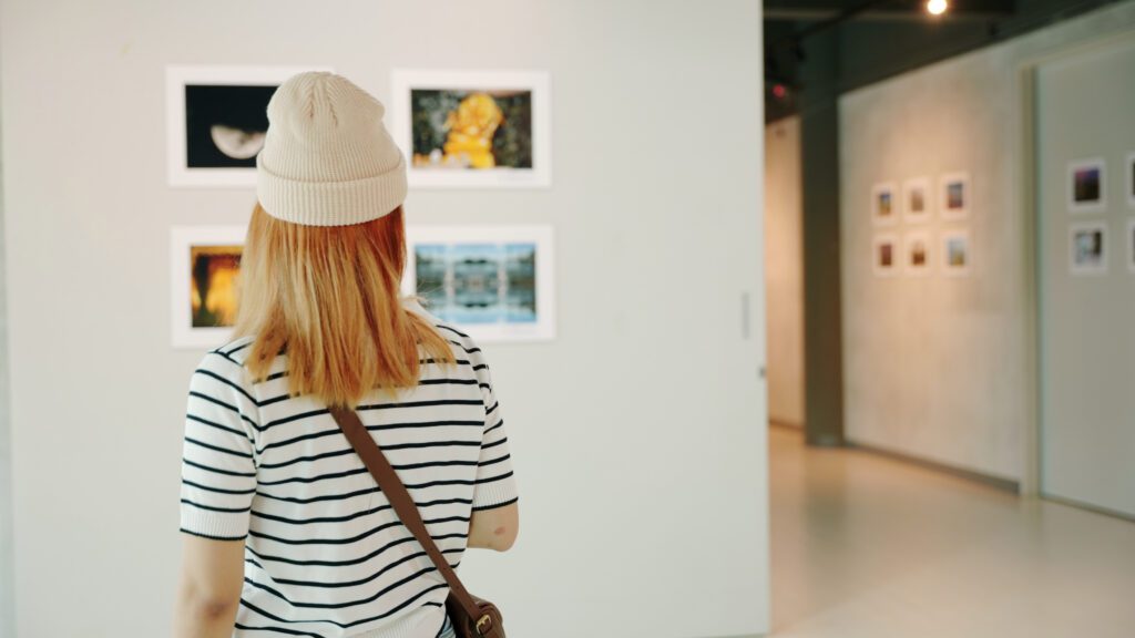 Image of a person in an art gallery looking at photography
