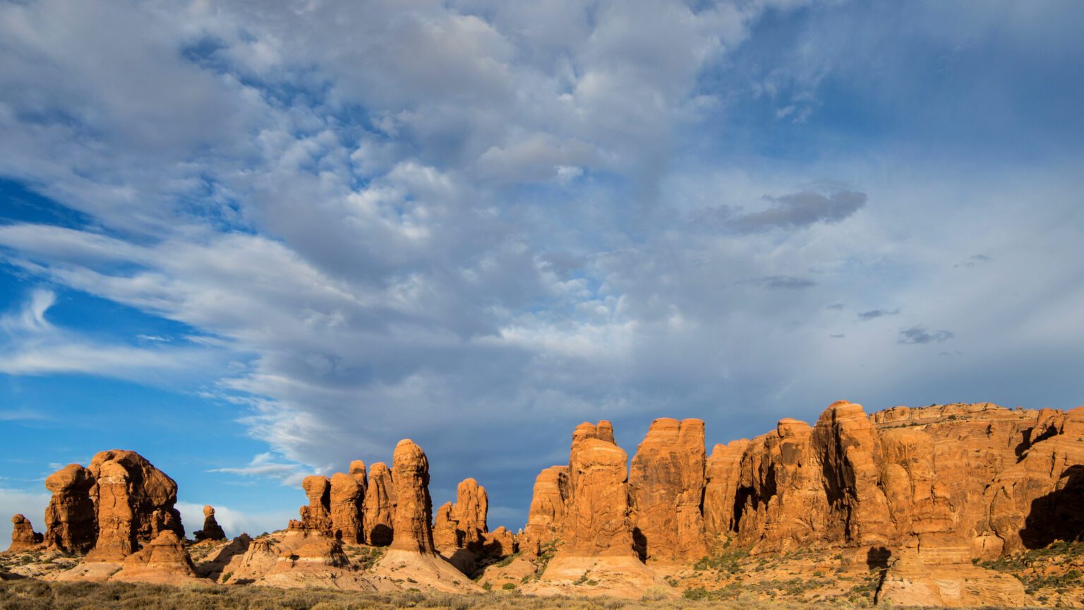 Image of the garden of eden in arches national park with clouds moving across the sky - A Creative Guide to Using Nature Stock Footage in Video Editing