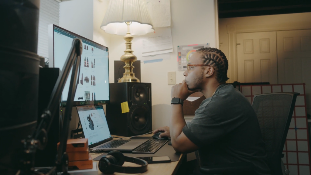 Handheld Shot Of Man Browsing On Computer